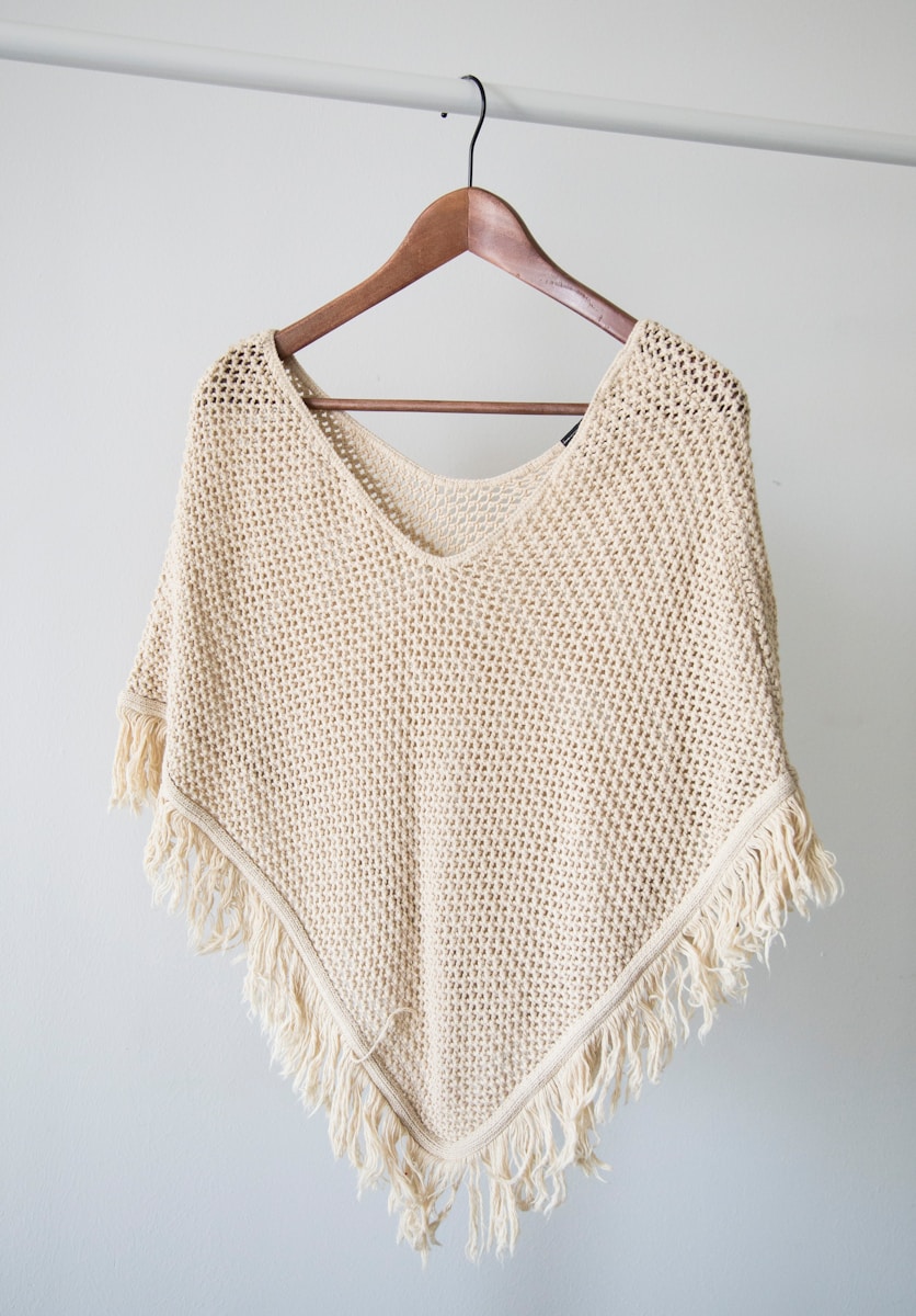 white v neck shirt on brown clothes hanger